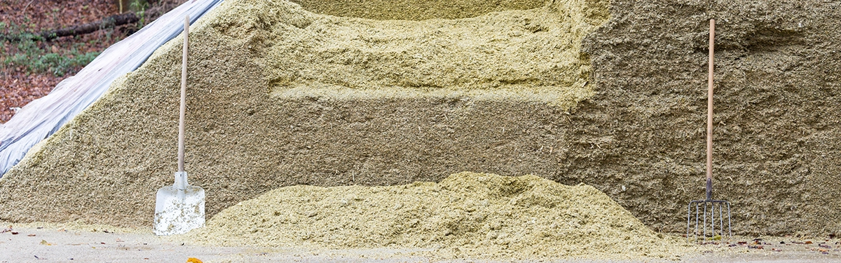 The Irish Farmer Guide to Feed Budgeting Farmer calculating winter feed budget and checking silage clamp